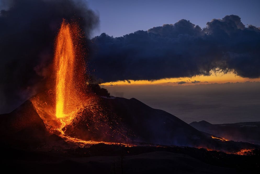 Lava flows from a volcano with increased seismic activity in recent days in the area on the Canary island of La Palma, Spain, Thursday, December 2, 2021. The Spanish National Geographic Institute recorded 341 earthquakes in the past 24 hours.  (AP Photo/Emilio Morenatti)