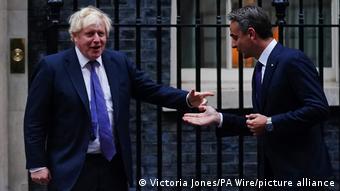 Boris Johnson and Kyriakos Mitsotakis in blue suits outside Downing Street