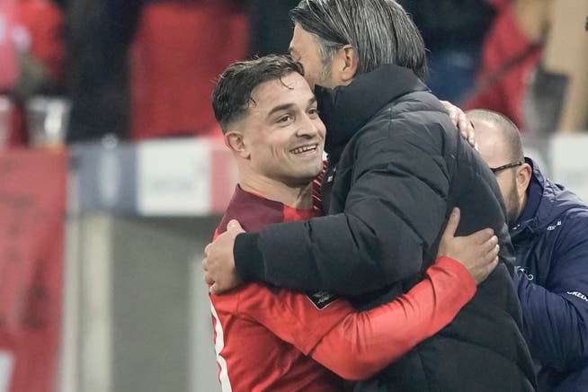 A warm hug after qualifying for the World Cup.  Xherdan Shaqiri and coach of the national team Mourad Yaqin. 