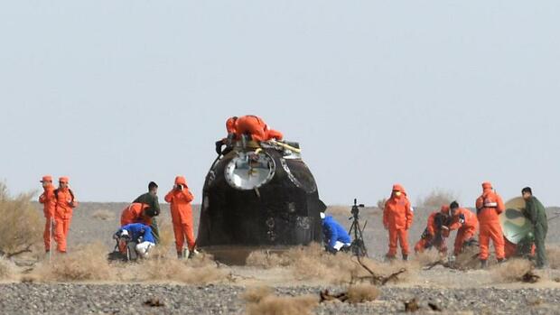 Chinese astronauts land on Earth after record flight