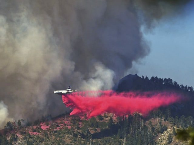 Firefighting plane over mountain hills.