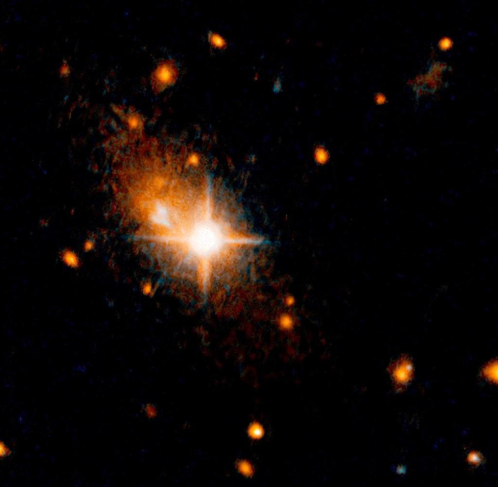 HANDOUT - A bright star-like quasar (center) that is the active core of a galaxy in front of the host galaxy can be seen.  (undated photo).  A tsunami with a giant gravitational wave caused a supermassive black hole to eject from the core of its host galaxy.  (to dpa 