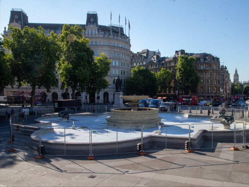 The fountain in Trafalgar Square without water.
