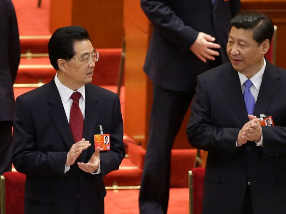Hu Jintao and Xi Jingping (left to right) applaud at the 2012 Party Congress.