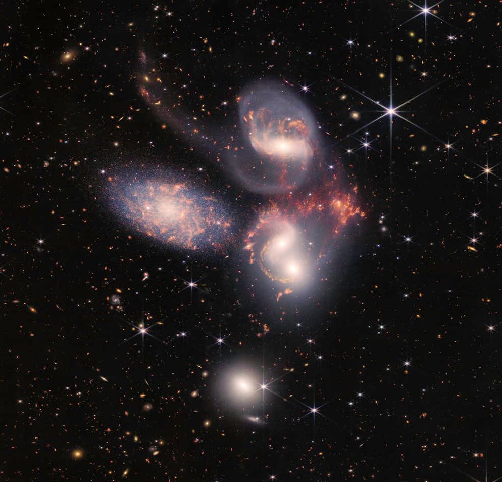 New James Webb photos.  Five galaxies in one image: Stephane's Quintet.  One of them crept in while the other four were gravity bound.